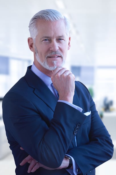 Director portrait on the production floor of a working facility — corporate photography