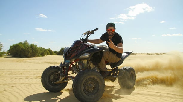 Aerial drone view of ATVs on an off-road trail